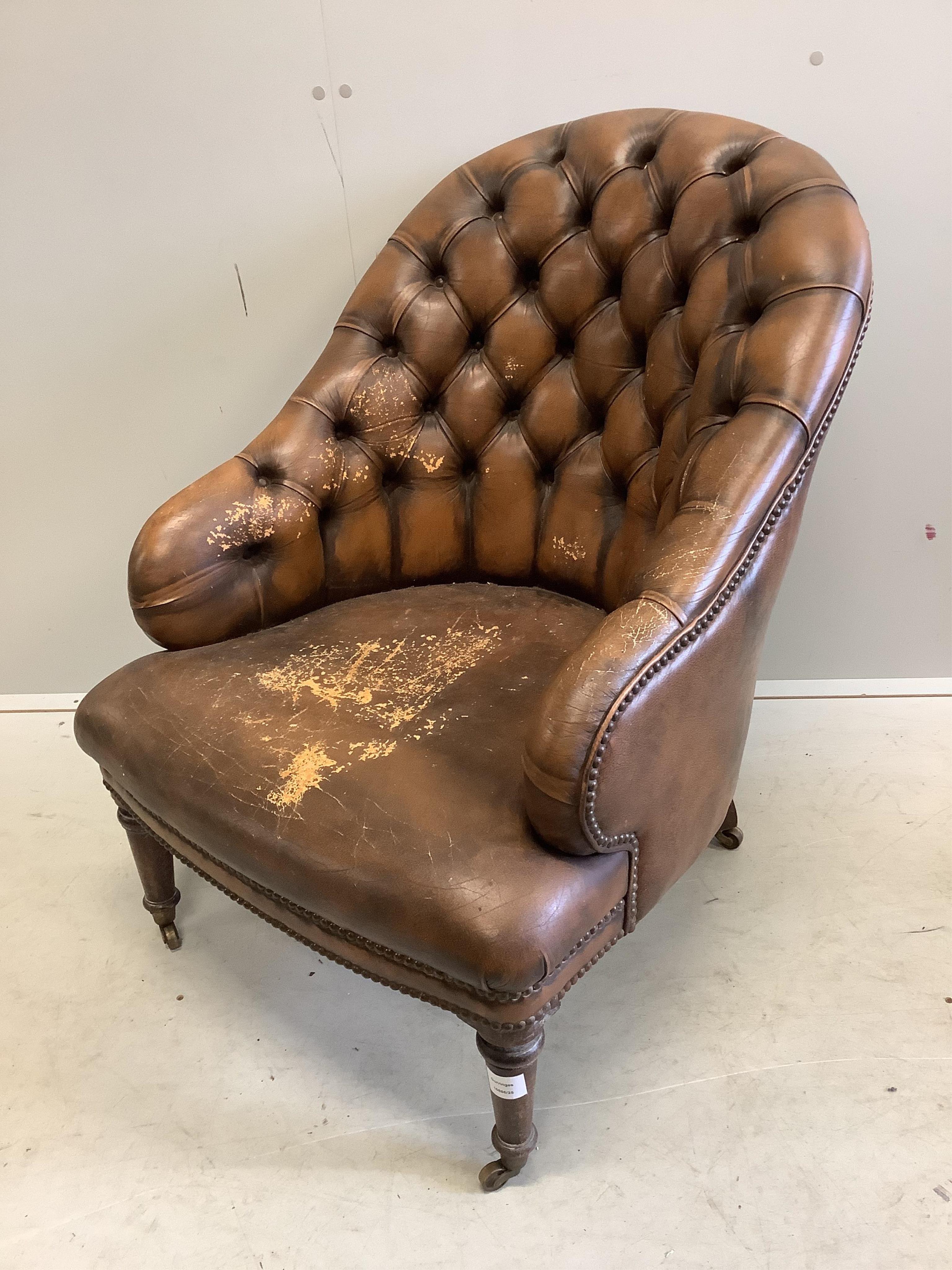 A Victorian style buttoned brown leather tub framed library chair, width 64cm, depth 74cm, height 80cm. Condition - fair, seat poor